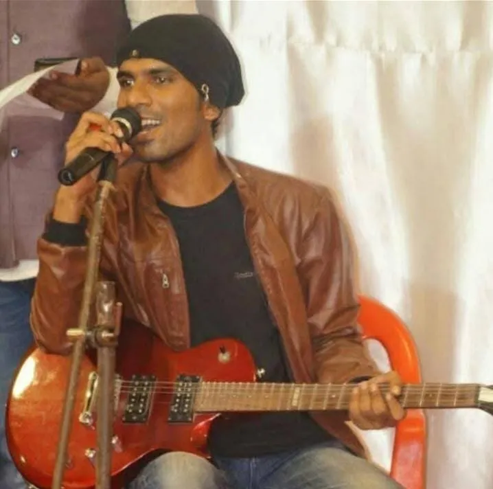 Sanket Survase playing electric guitar at a live show