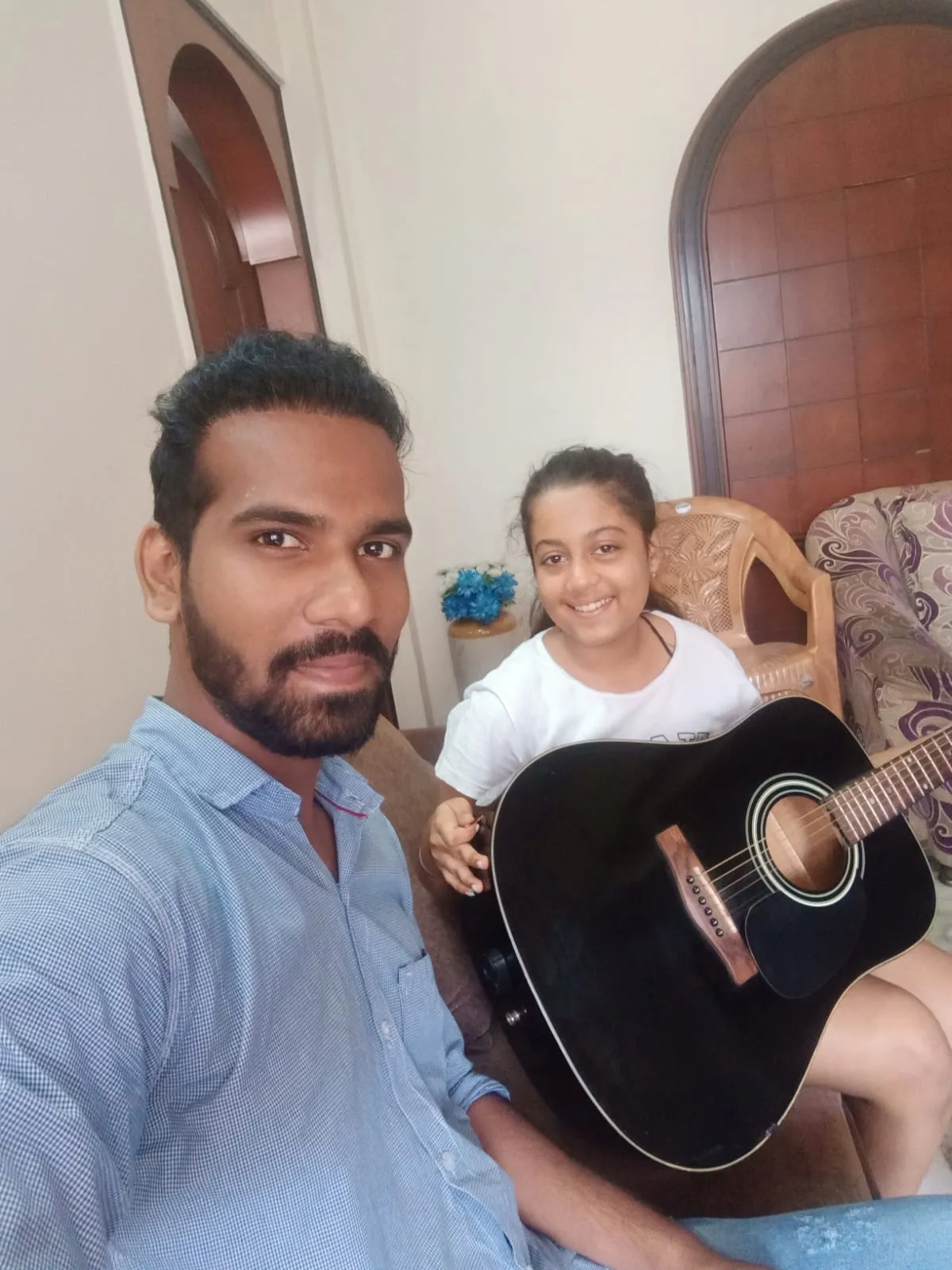 A child learning to hold her first chords