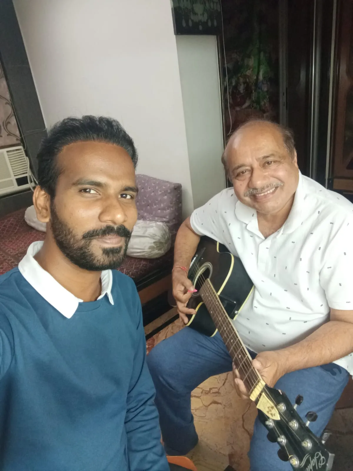 A senior student enjoying a guitar lesson