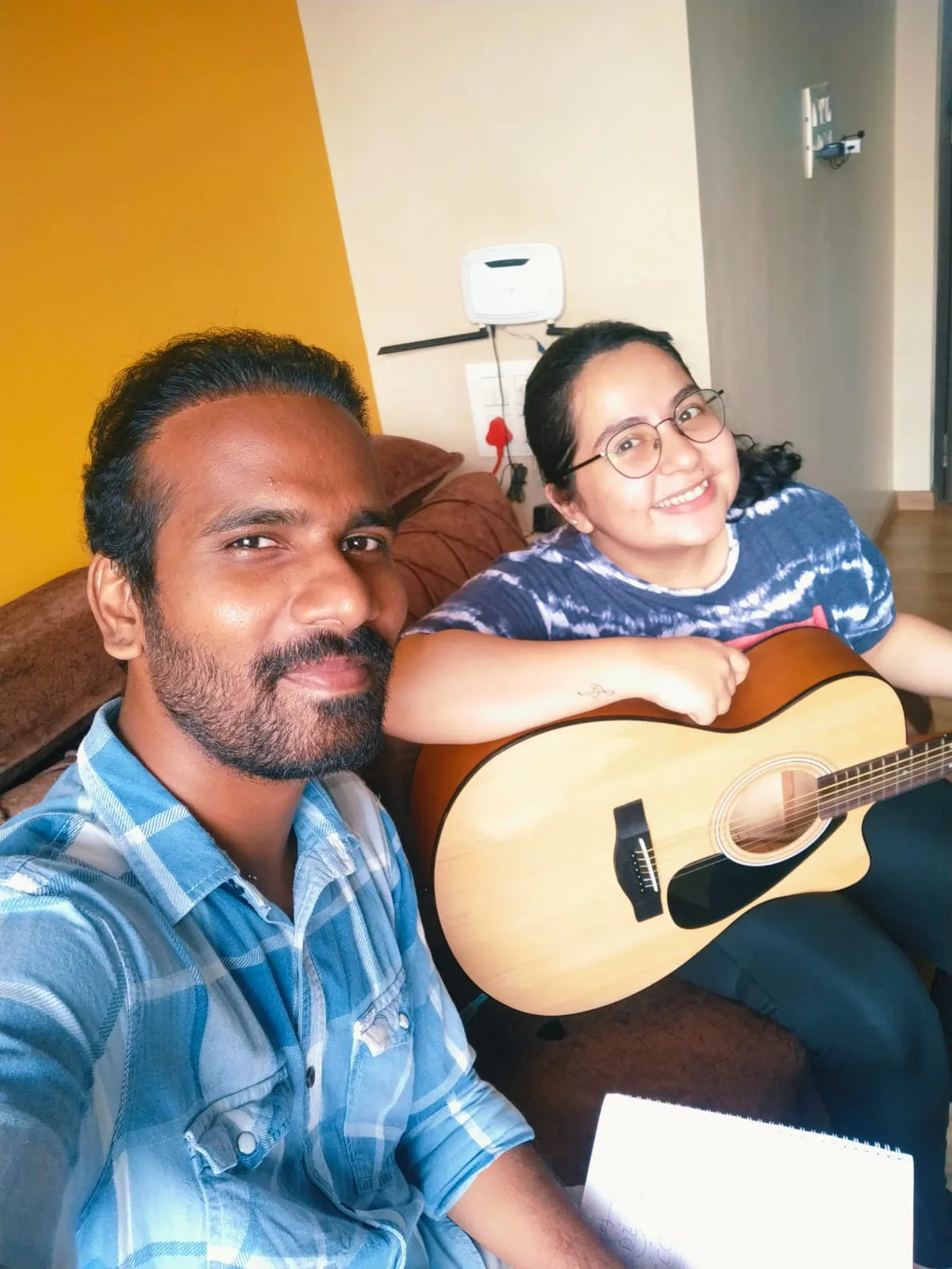 A young adult learning acoustic guitar